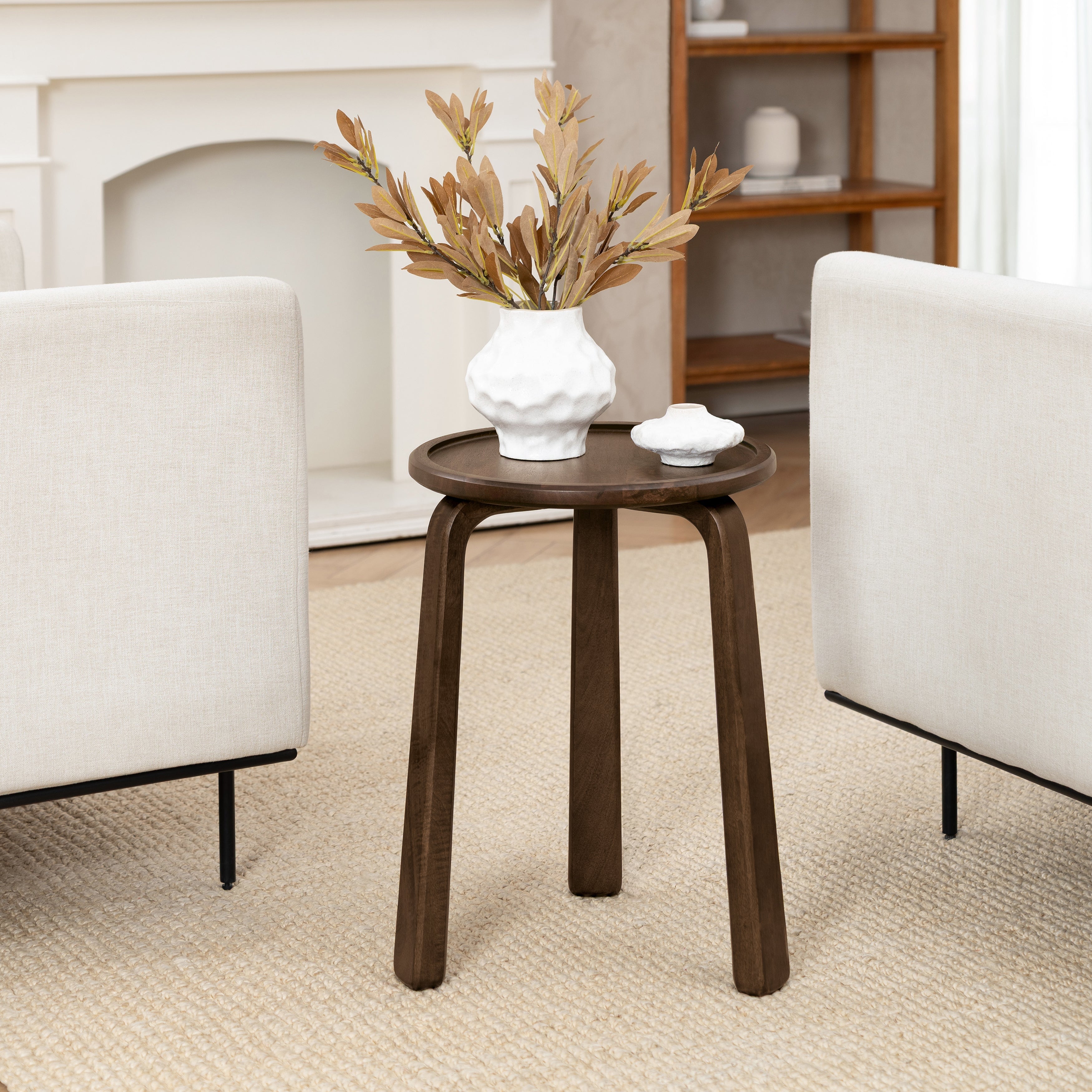 Wooden side table with decorative items in a living room setting