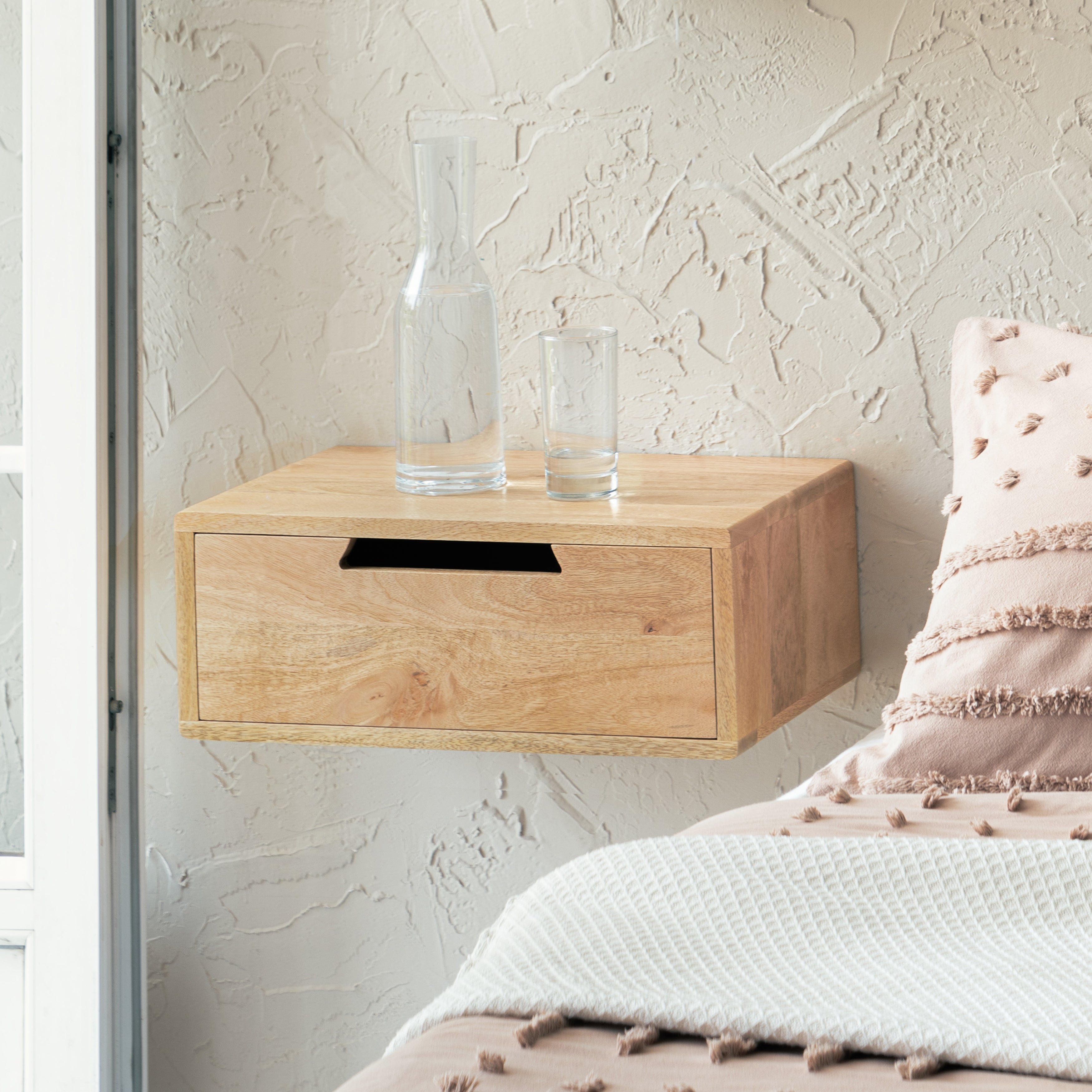 Wooden bedside table with a handle on a white background
